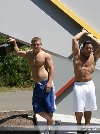 Muscular gay studs Tommy D & Hoyce flaunting their mighty chests outdoors
