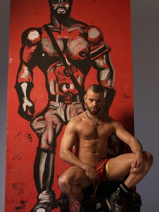 Sexy gay bodybuilder Manuel Roko poses in a hot setting with chains