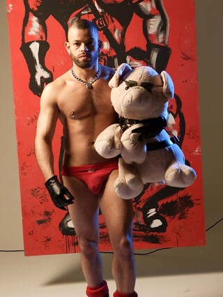 Sexy gay bodybuilder Manuel Roko poses in a hot setting with chains